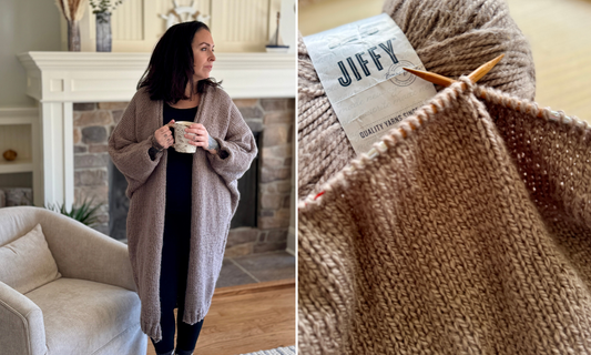woman wearing an oversized knit cardigan holding a coffee mug