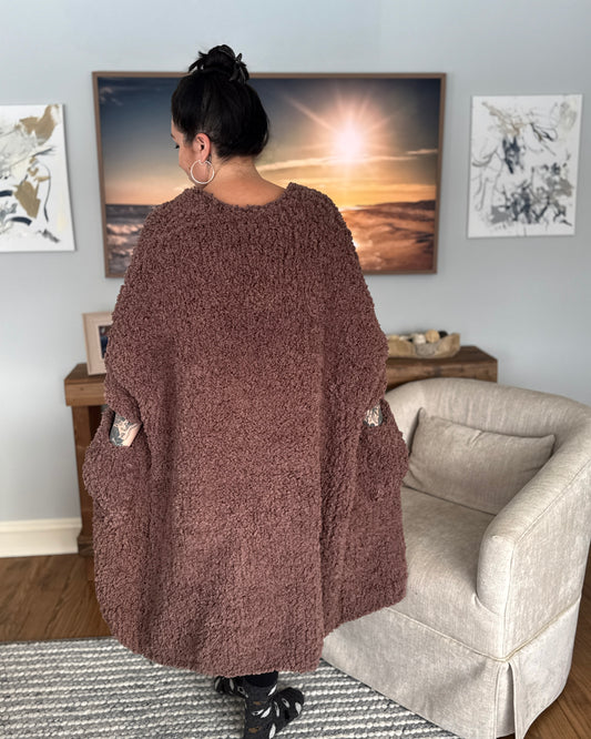 Woman facing back wearing a jumbo knit robe