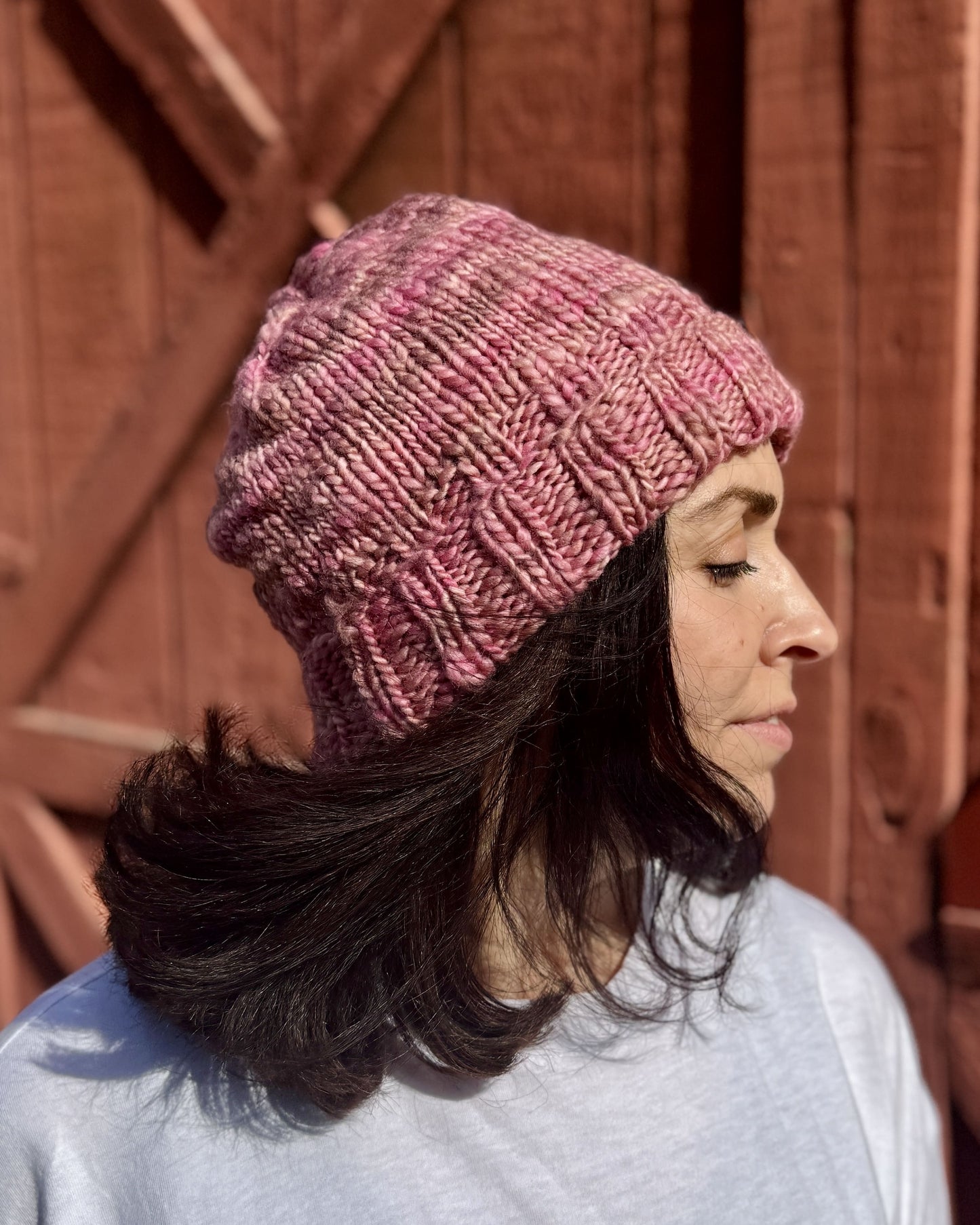 woman wearing a pink knit beanie hat pattern