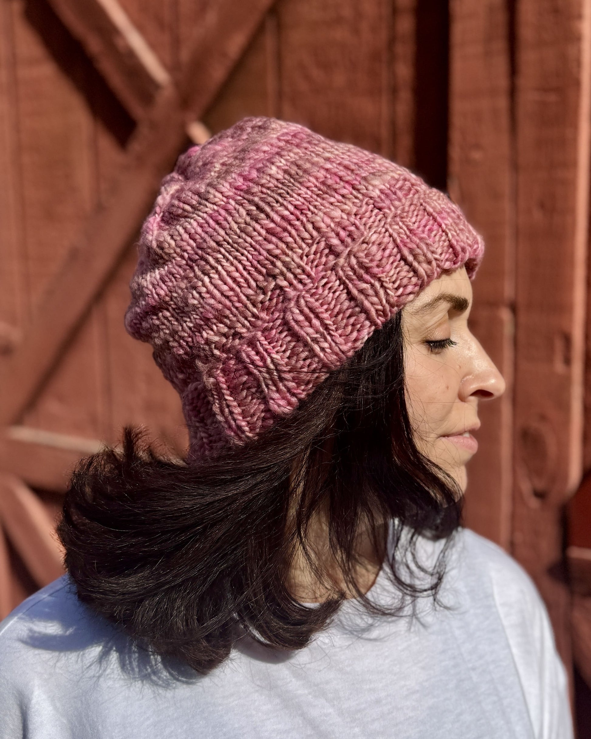 woman wearing a pink knit beanie hat pattern