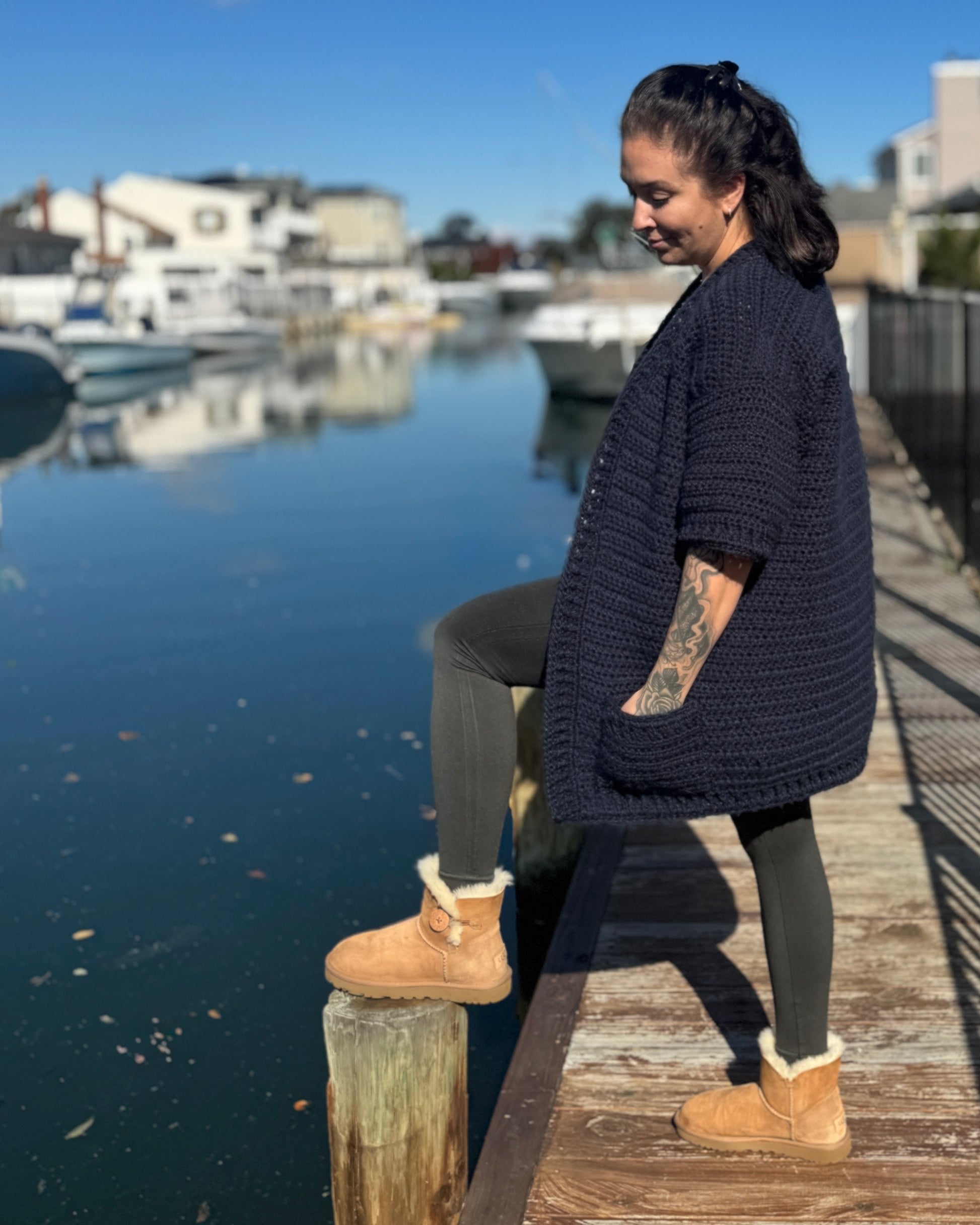 Side angle of the crochet cardigan highlighting pocket placement and sleeve length.